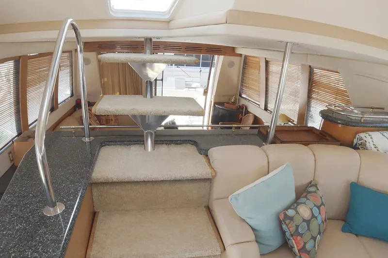 Slide: The Image of Interior of 1999 Carver 53 Voyager yacht with modern staircase and plush seating. - 12