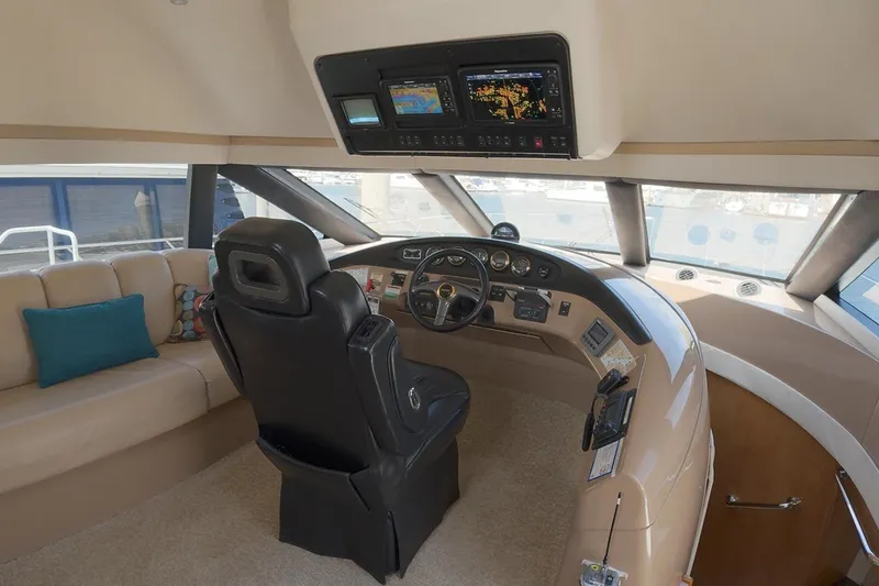 Slide: The Image of 1999 Carver 53 Voyager yacht helm with leather seating and advanced navigation displays. - 13