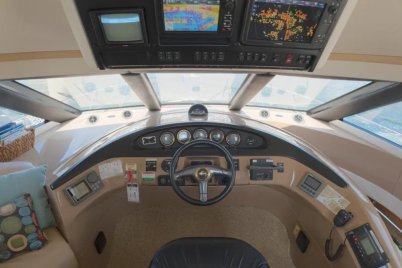 Slide: The Image of 1999 Carver 53 Voyager helm with navigation screens and steering wheel. - 14