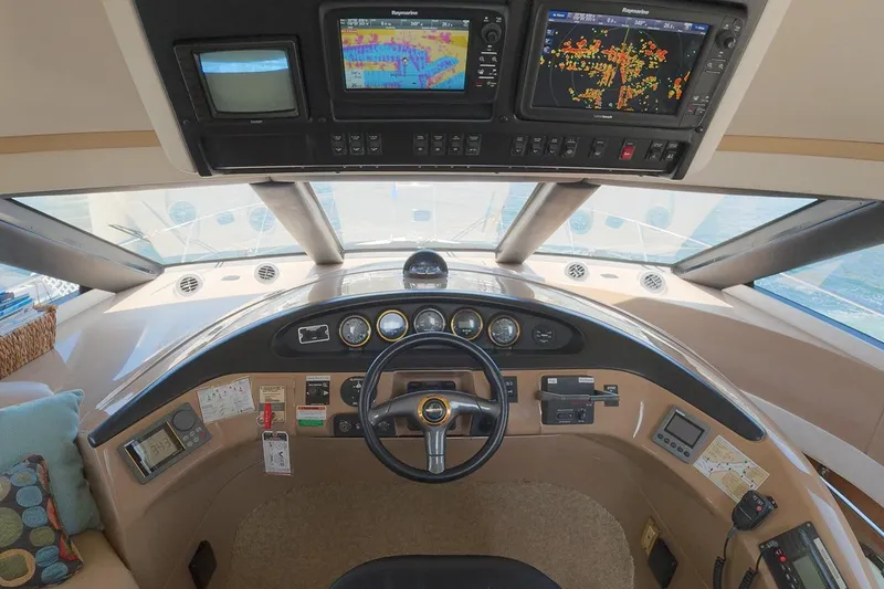 Slide: The Image of 1999 Carver 53 Voyager helm with navigation screens and steering wheel. - 16