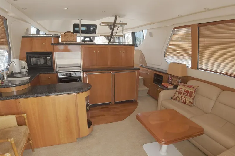 Slide: The Image of Interior of 1999 Carver 53 Voyager yacht with modern kitchen and cozy seating area. - 2