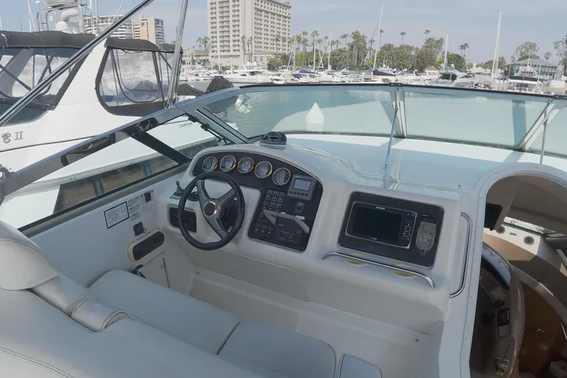 Slide: The Image of 1999 Carver 53 Voyager yacht helm with steering wheel and navigation controls. - 21