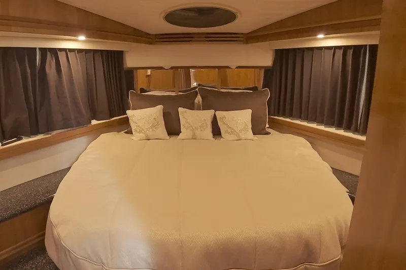 Slide: The Image of Luxurious bedroom interior of 1999 Carver 53 Voyager yacht with cozy bedding and elegant decor. - 26