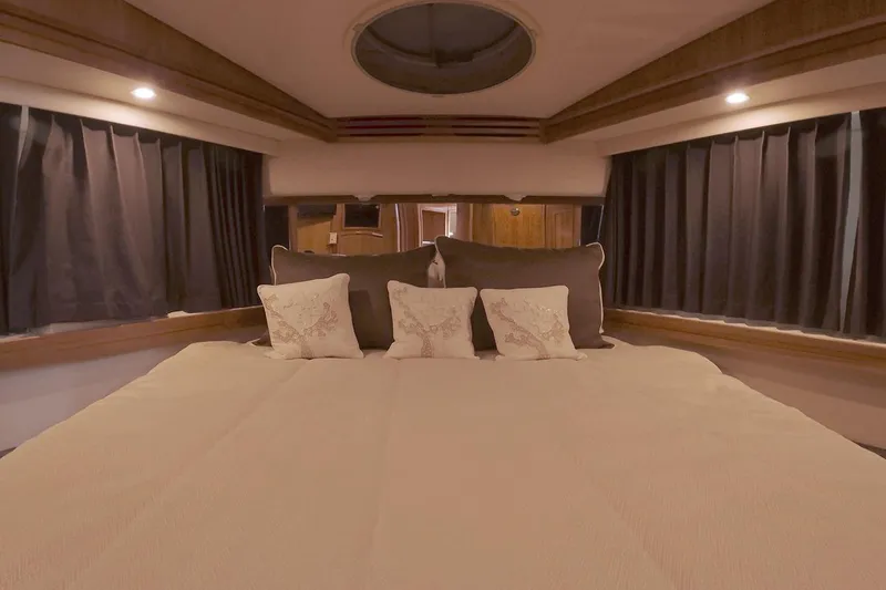 Slide: The Image of Luxurious bedroom interior of 1999 Carver 53 Voyager yacht with elegant bedding. - 28