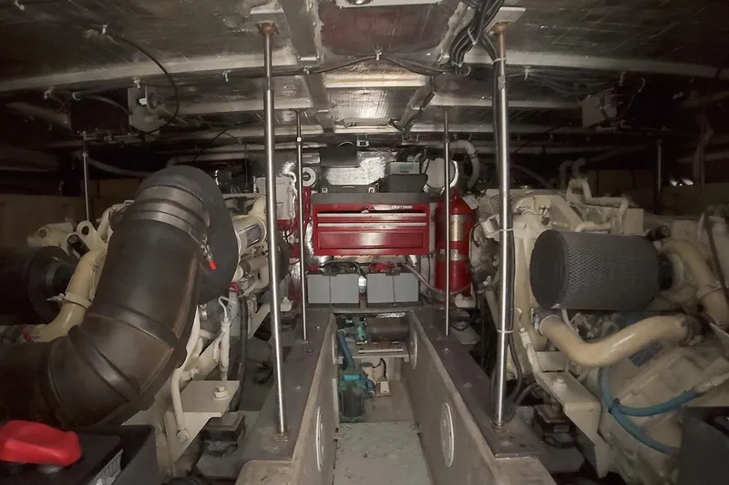 Slide: The Image of Engine room of a 1999 Carver 53 Voyager yacht, showcasing mechanical components. - 29