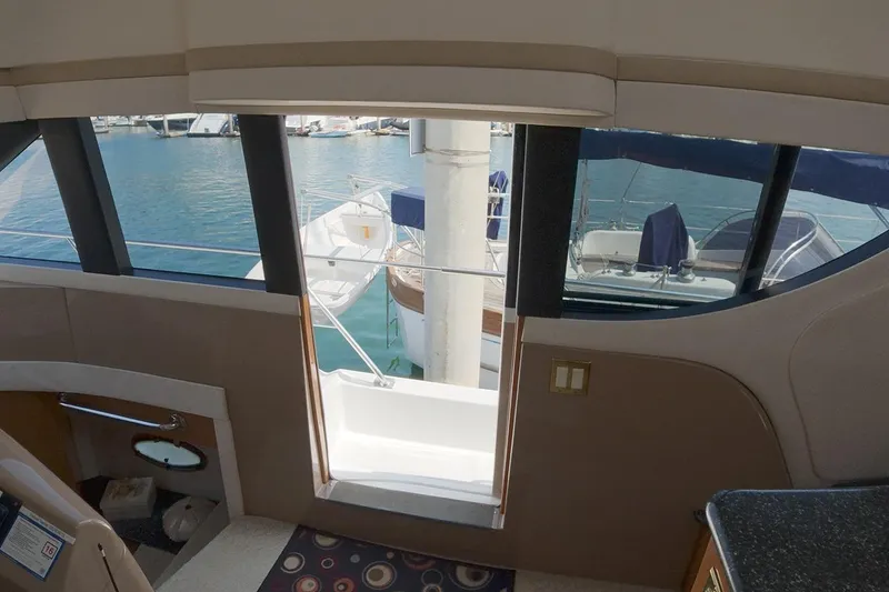 Slide: The Image of Interior view from a 1999 Carver 53 Voyager yacht, overlooking marina through large windows. - 5