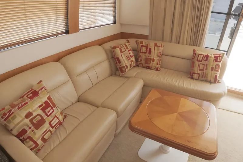Slide: The Image of Luxurious interior of 1999 Carver 53 Voyager yacht with beige leather seating and patterned cushions. - 7