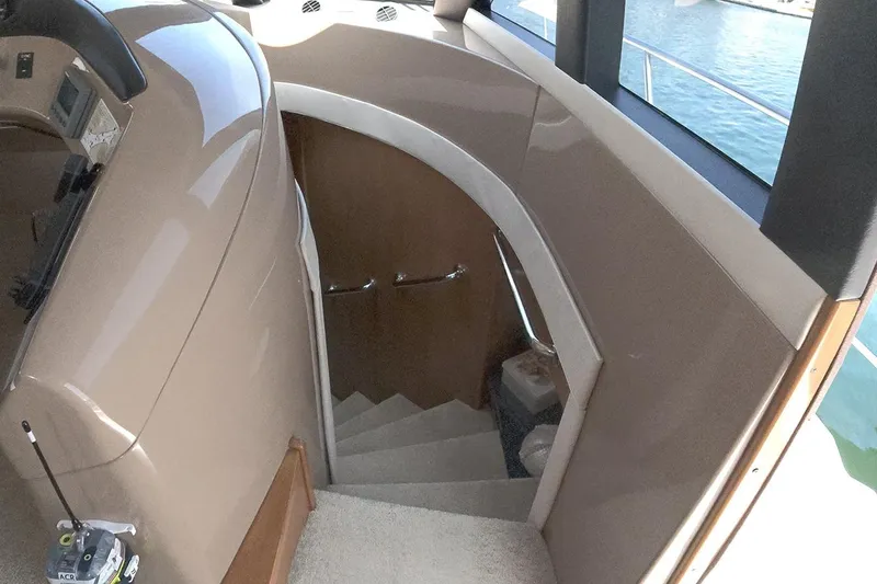 Slide: The Image of Interior staircase of 1999 Carver 53 Voyager yacht, featuring elegant design and wood accents. - 8
