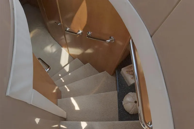 Slide: The Image of Staircase inside 1999 Carver 53 Voyager yacht with wooden paneling and carpeted steps. - 9