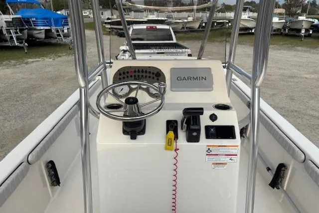 Slide: The Image of 2024 Carolina Skiff 25 LS boat console with Garmin navigation system and steering wheel. - 10