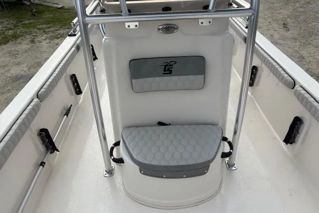 Slide: The Image of 2024 Carolina Skiff 25 LS boat interior with cushioned seating and stainless steel railings. - 21
