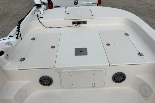 Slide: The Image of 2024 Carolina Skiff 25 LS boat deck with storage compartments and speakers. - 22