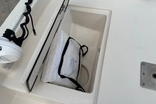 Slide: The Image of Storage compartment on 2024 Carolina Skiff 25 LS boat with life jacket inside. - 23