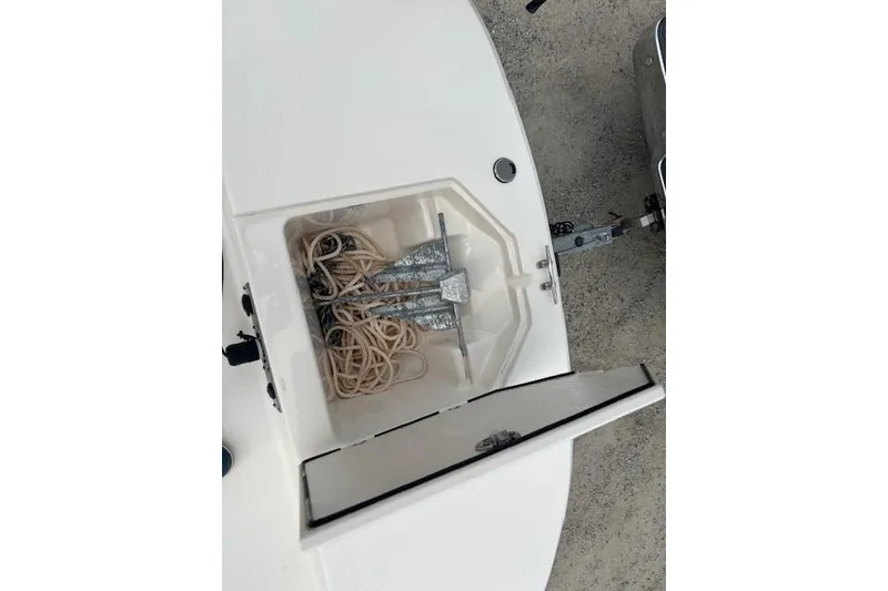 Slide: The Image of 2024 Carolina Skiff 25 LS anchor storage compartment with rope and anchor. - 25