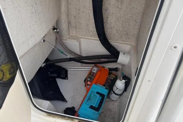 Slide: The Image of Storage compartment of 2024 Carolina Skiff 25 LS with tools and equipment. - 32