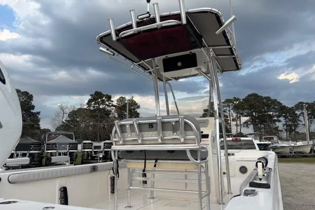 Slide: The Image of 2024 Carolina Skiff 25 LS boat with T-top, docked under cloudy sky. - 35