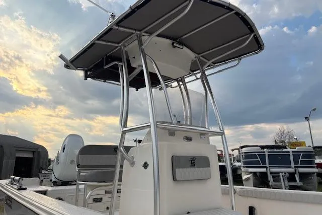 Slide: The Image of 2024 Carolina Skiff 25 LS boat with T-top against a cloudy sky backdrop. - 36