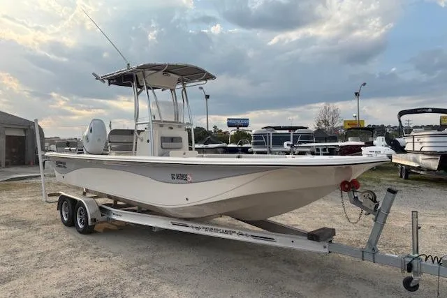 Slide: The Image of 2024 Carolina Skiff 25 LS boat on trailer, parked outdoors under cloudy sky. - 7