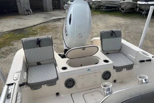 Slide: The Image of 2024 Carolina Skiff 25 LS boat interior with seating and motor, showcasing modern design. - 9