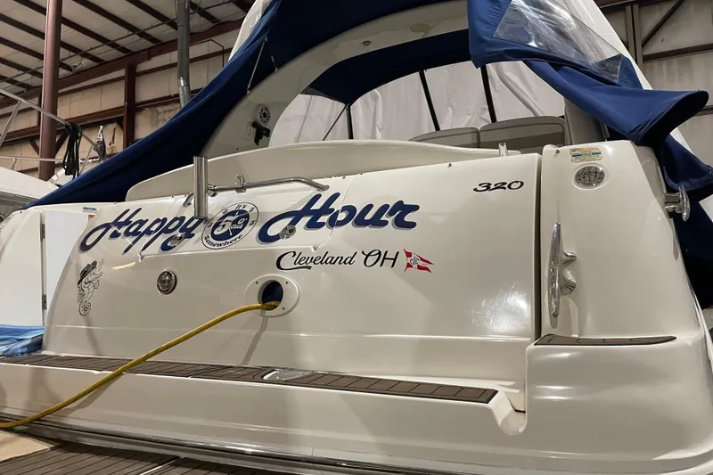 The Image of 2002 Sea Ray Sundancer 320 boat named "Happy Hour" docked indoors. - 0