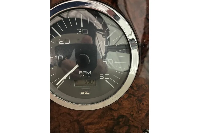 Slide: The Image of Close-up of a 2002 Sea Ray Sundancer 320 RPM gauge showing 590 hours. - 10