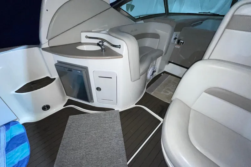 Slide: The Image of Interior of 2002 Sea Ray Sundancer 320 with seating, sink, and mini fridge. - 13