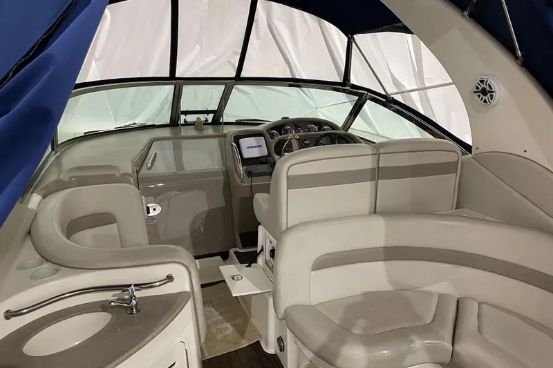 Slide: The Image of Interior of a 2002 Sea Ray Sundancer 320 boat with beige seating and helm. - 16