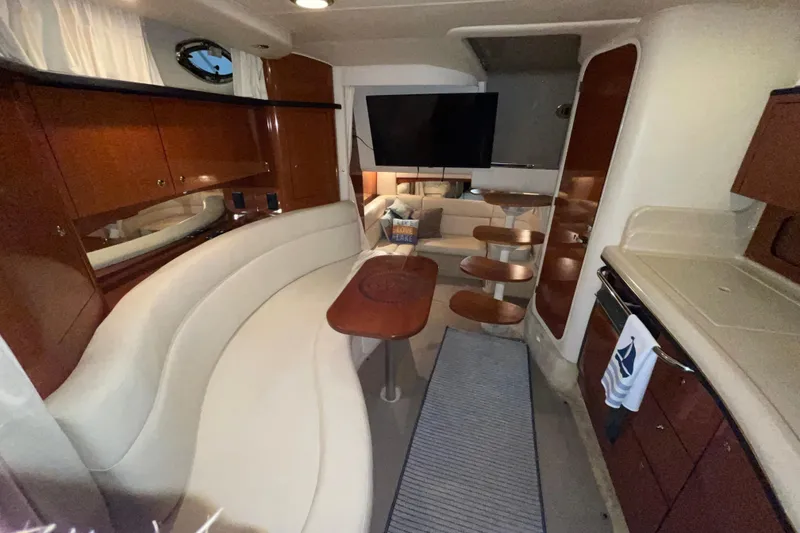 Slide: The Image of Interior of 2002 Sea Ray Sundancer 320 yacht with elegant seating and modern amenities. - 17