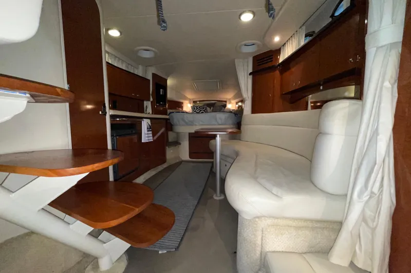 Slide: The Image of Interior of 2002 Sea Ray Sundancer 320 yacht with wooden stairs and cozy seating. - 18