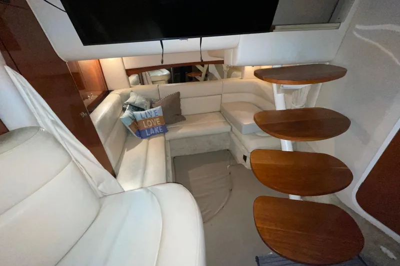 Slide: The Image of Interior of 2002 Sea Ray Sundancer 320 with cozy seating and wooden steps. - 21