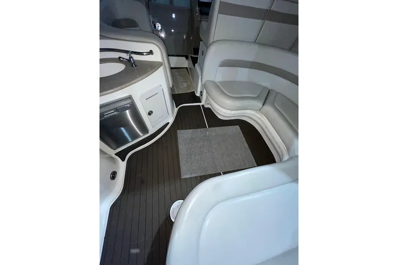 Slide: The Image of Interior of 2002 Sea Ray Sundancer 320 with seating, kitchenette, and wood flooring. - 26
