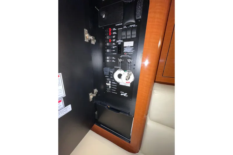 Slide: The Image of Electrical panel inside a 2002 Sea Ray Sundancer 320 yacht, featuring switches and keys. - 28