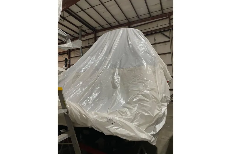 Slide: The Image of 2002 Sea Ray Sundancer 320 covered in protective tarp inside a warehouse. - 31