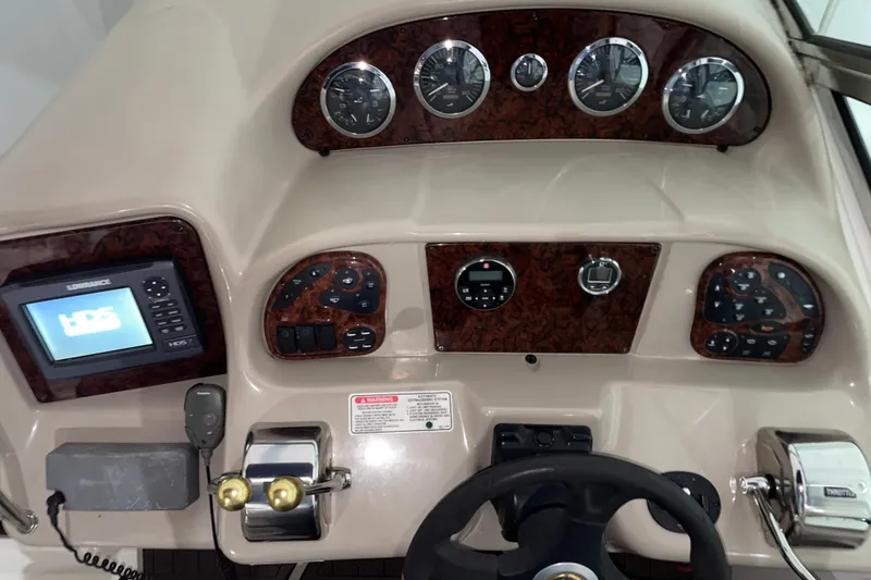 Slide: The Image of Dashboard of a 2002 Sea Ray Sundancer 320 boat with navigation controls and gauges. - 5