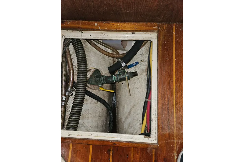 Slide: The Image of Bilge area of 1989 Pacific Seacraft 37 sailboat showing hoses and fittings. - 45