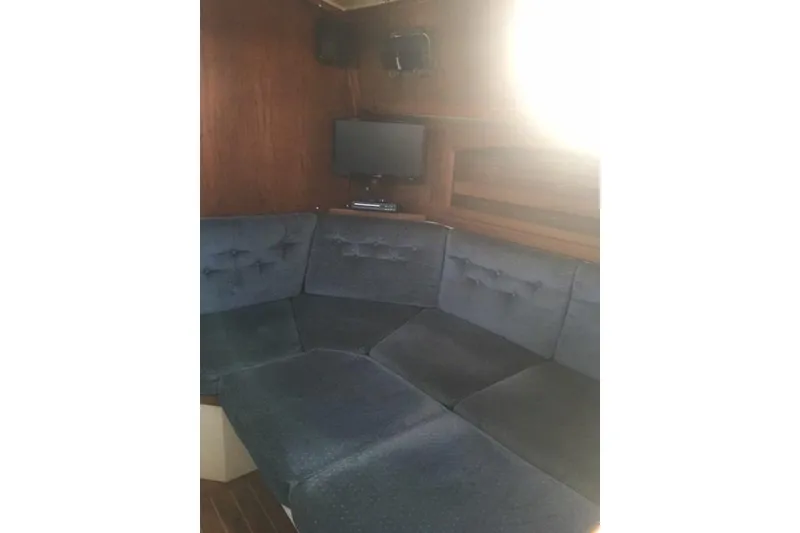 Slide: The Image of Cozy interior of 1989 Pacific Seacraft 37 sailboat with wooden cabinetry and seating area. - 18