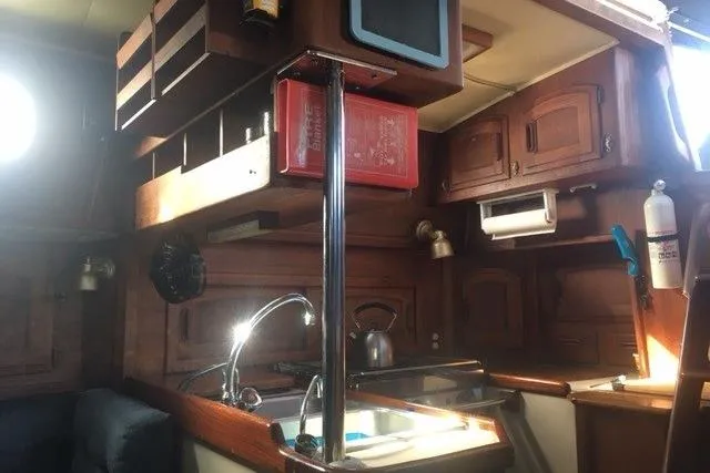 Slide: The Image of Cozy interior of 1989 Pacific Seacraft 37 sailboat with wooden table and blue seating. - 19