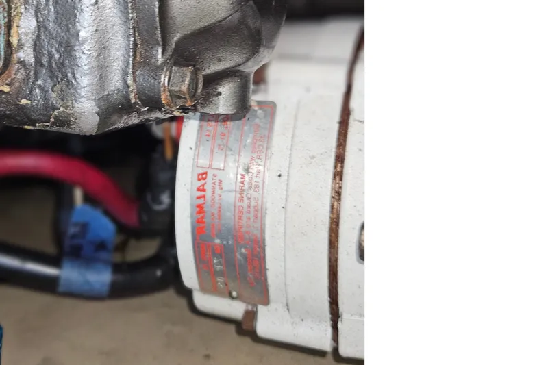 Slide: The Image of Close-up of a boat engine with cables and a label showing technical details. - 44
