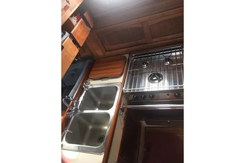 Slide: The Image of Galley kitchen of 1989 Pacific Seacraft 37 sailboat with stove and double sink. - 25