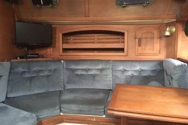 Slide: The Image of Interior of 1989 Pacific Seacraft 37 sailboat with cozy seating and wooden table. - 26