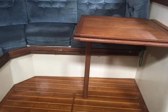 Slide: The Image of Cozy interior of 1989 Pacific Seacraft 37 sailboat with blue cushioned seating. - 27