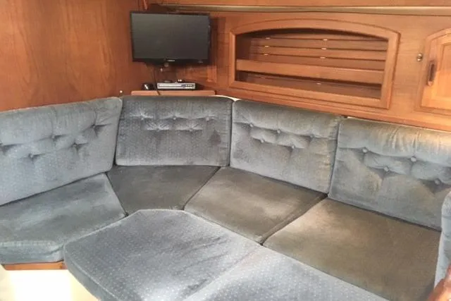 Slide: The Image of Interior of 1989 Pacific Seacraft 37 with wooden table and cushioned seating. - 29