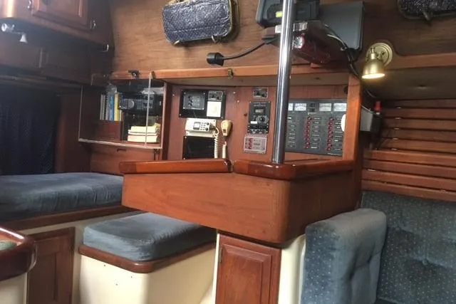 Slide: The Image of Cozy interior of 1989 Pacific Seacraft 37 sailboat with wooden table and blue seating. - 30