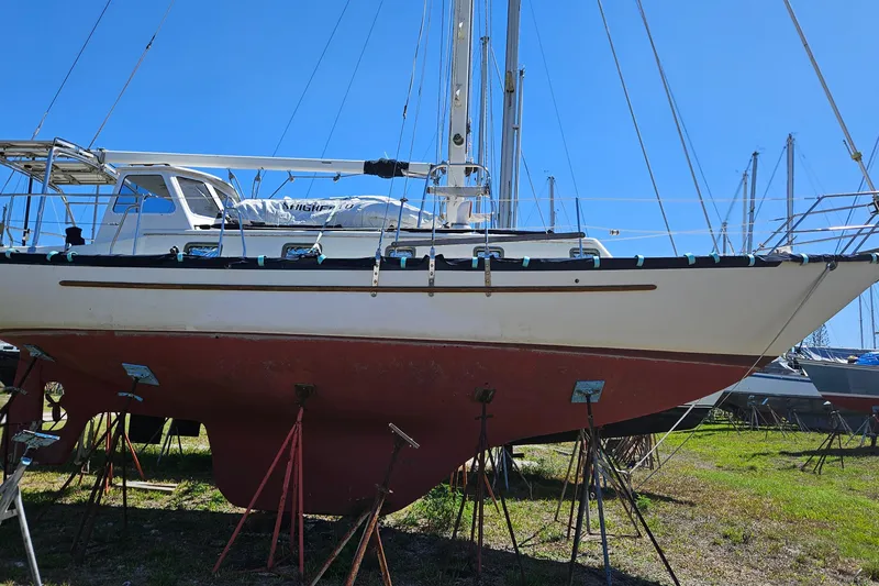 Slide: The Image of Navigation station of a 1989 Pacific Seacraft 37 sailboat with control panels and radio equipment. - 33