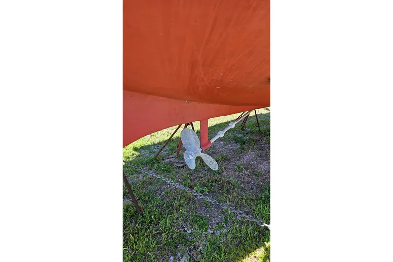 Slide: The Image of 1989 Pacific Seacraft 37 sailboat on stands, viewed from the stern, under clear blue sky. - 38