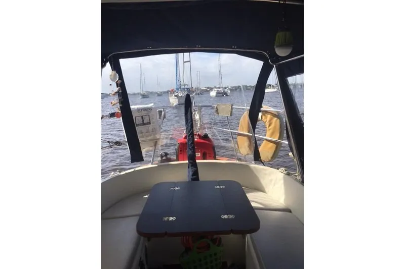 Slide: The Image of Cockpit view from a 1989 Pacific Seacraft 37 sailboat, overlooking a marina. - 43