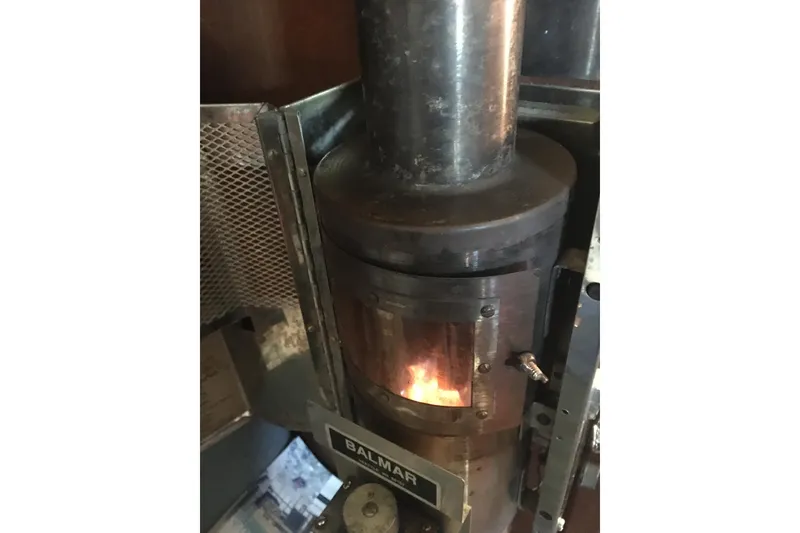 Slide: The Image of Wood stove inside 1989 Pacific Seacraft 37 sailboat, featuring Balmar heater. - 45