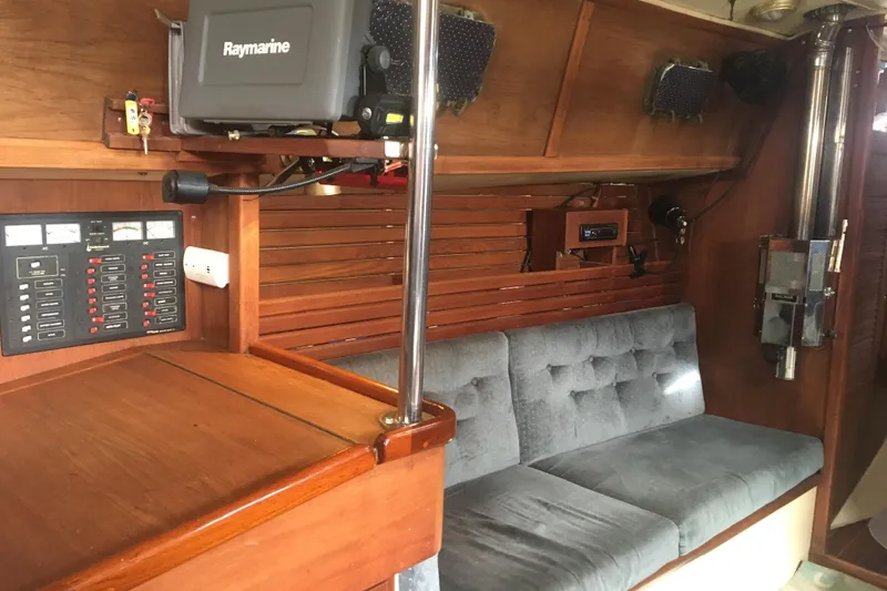 Slide: The Image of Interior of 1989 Pacific Seacraft 37 sailboat with navigation equipment and cushioned seating. - 46