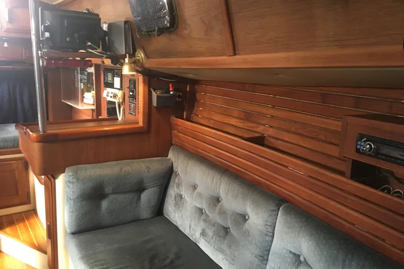 Slide: The Image of Interior of 1989 Pacific Seacraft 37 sailboat with wood paneling and cushioned seating. - 47