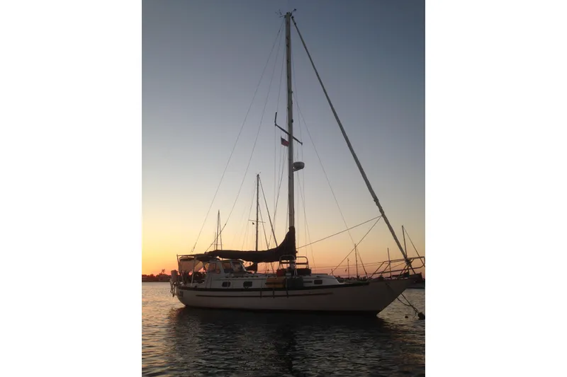 Slide: The Image of 1989 Pacific Seacraft 37 sailboat at sunset on calm waters. - 51